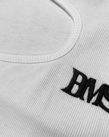 Detail view of our cut out ribbed top in color white with black logo embroidery summer top 