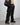 Full outfit view of our survivor unisex baggy pants / jeans in black color with silver elements and detachable sidepocket 