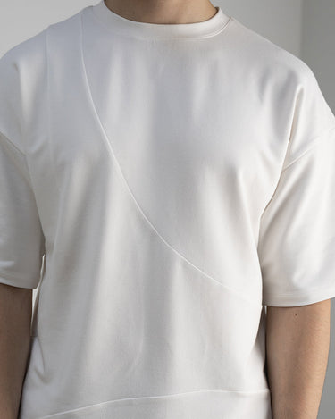 Detail front view of our cropped unisex t-shirt with pattern overlay in color cream. 