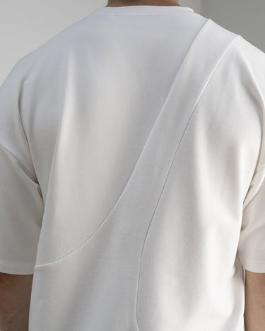 Detail back view of our cropped unisex t-shirt with pattern overlay in color cream. 